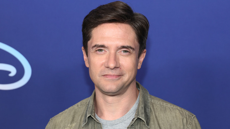 Topher Grace smirking