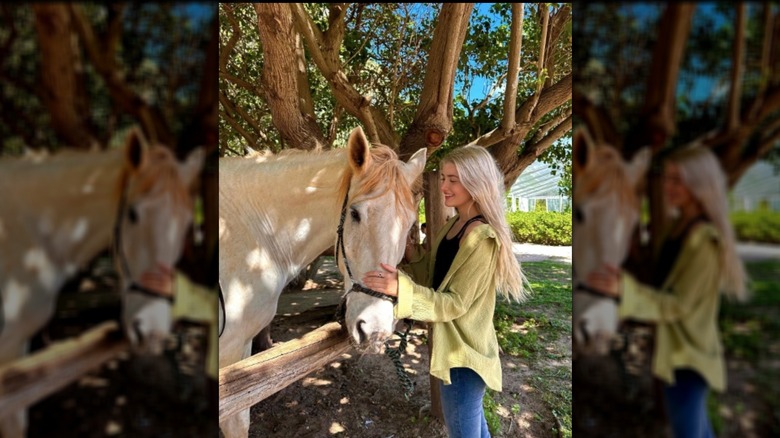 Sami Sheen petting horse