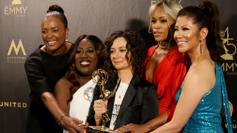 The cast of The Talk holding Emmy