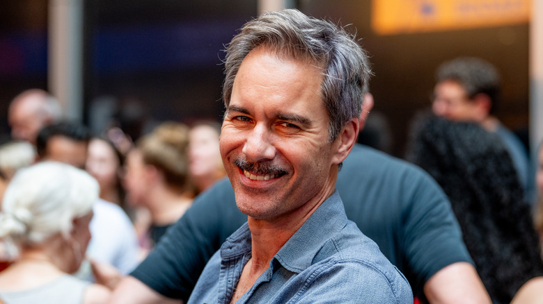 Grinning Eric McCormack in audience