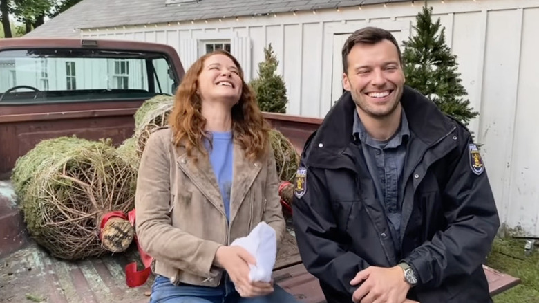 Sarah Drew and Peter Mooney laughing on set of "Mistletoe Murders"