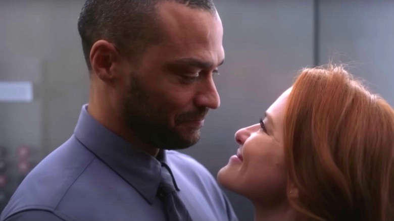 Jesse Williams and Sarah Drew smiling at eachother