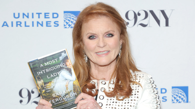 Sarah Ferguson holding her book on red carpet