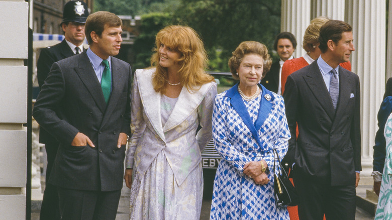 Prince Andrew, Sarah Ferguson, Queen Elizabeth II, and King Charles III standing together