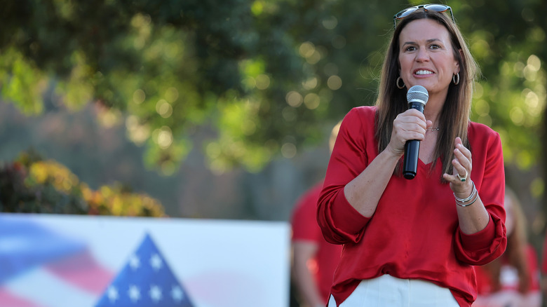 Sarah Huckabee Sanders speaking into a mic