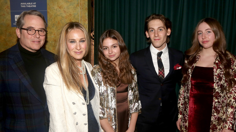 Matthew Broderick and Sarah Jessica Parker standing with their three children