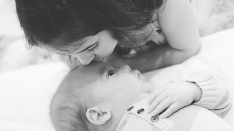 Charlotte kissing Rocky as a baby