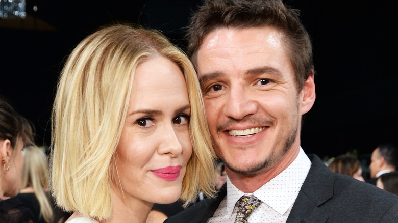 Pedro Pascal and Sarah Paulson smiling. 