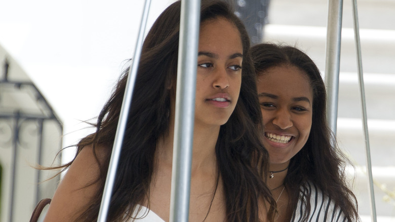 Malia and Sasha walking together