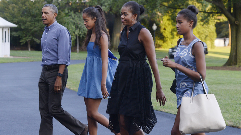 Barack, Malia, Michelle, and Sasha Obama walking