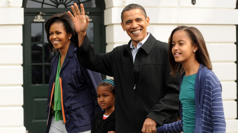 Michelle Obama Barack Obama smiling, walking with Sasha Obama Malia Obama