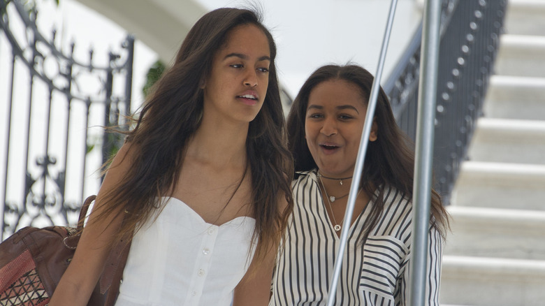 Young Malia and Sasha Obama walking together