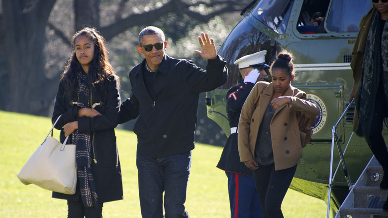 Malia and Sasha Obama pictured with their father on the Front Lawn