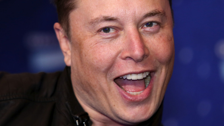 close up of Elon Musk smiling