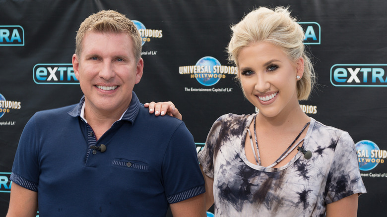 Savannah and Todd Chrisley pose on the red carpet