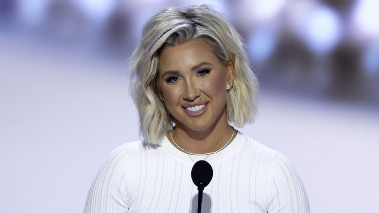 Savannah Chrisley smiling at podium