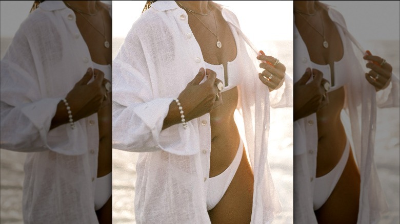 Model in a white bikini and oversize shirt