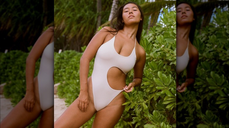 Model in a white cut-out style swimsuit