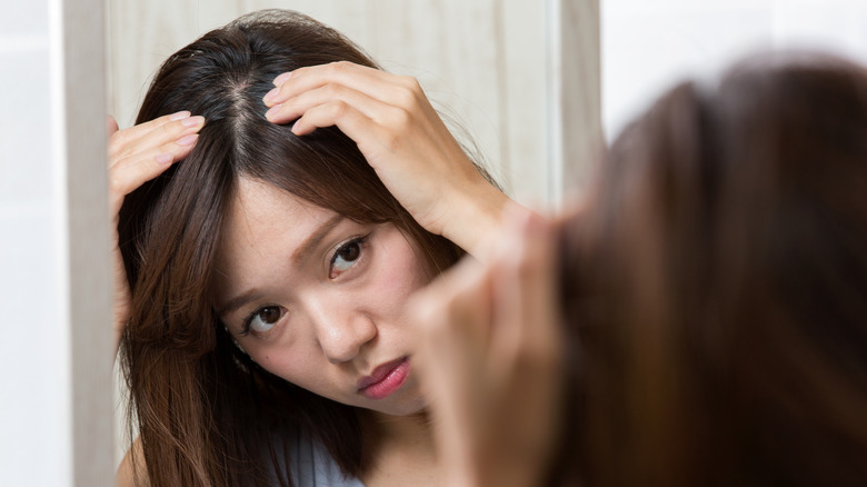 Woman looking at scalp