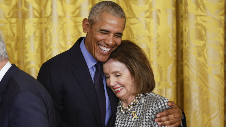 Barack Obama and Nancy Pelosi smiling