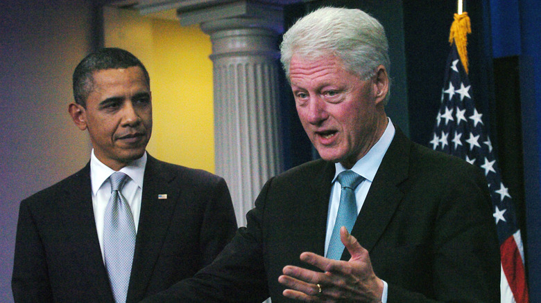 Barack Obama looking at Bill Clinton talking