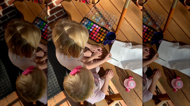 Top down view of Erin Napier's two daughter's playing with paint