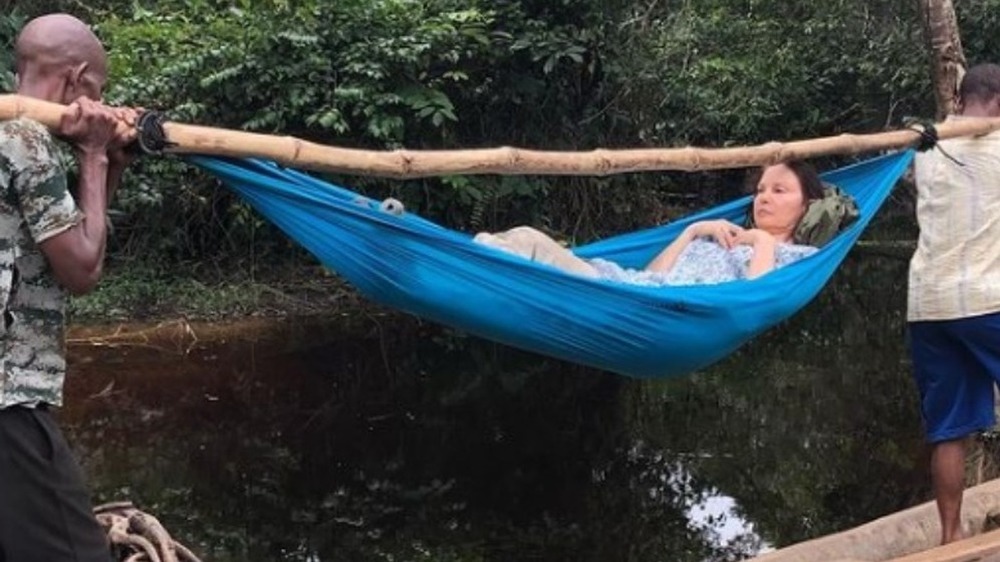 Ashley Judd being carried in hammock after leg injury