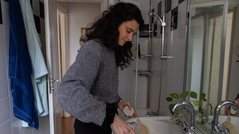 woman cleaning bathroom sink