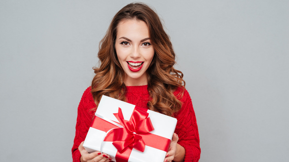 Happy woman holding holiday gift