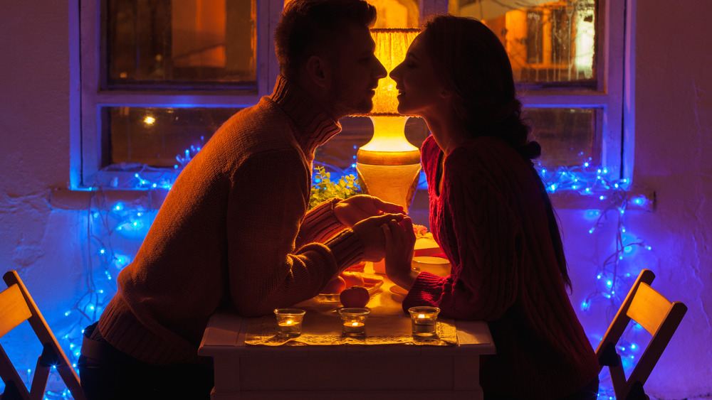 Couple about to kiss at romantic dinner