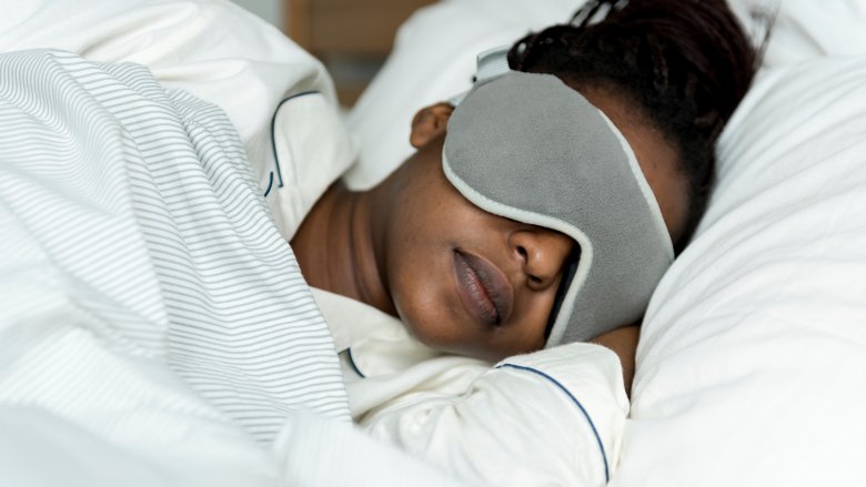 A woman sleeping with a mask on