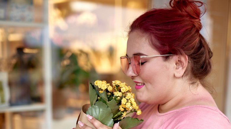 A woman smelling flowers