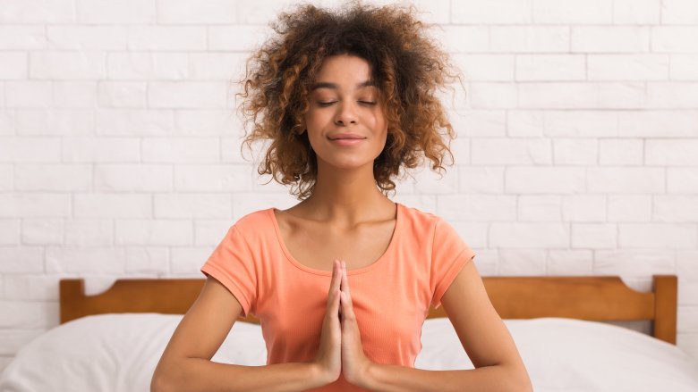 A woman with her palms together