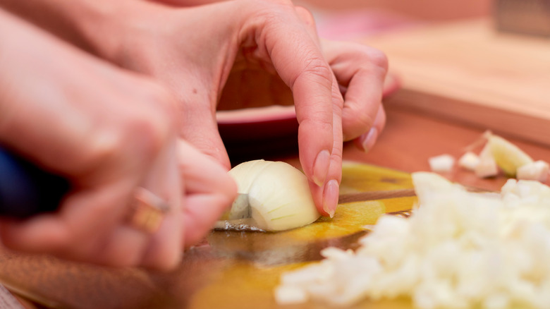 chopping onions to make natural remedy