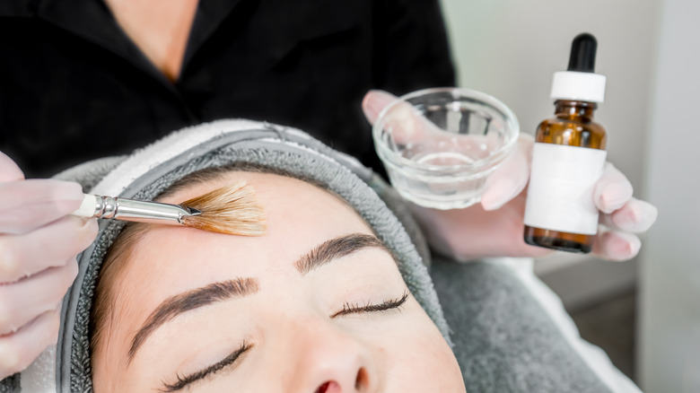 Woman applying a skin treatment