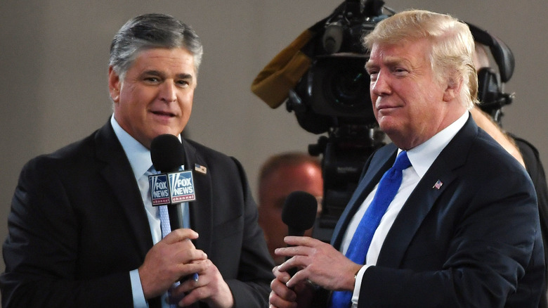 Sean Hannity and Donald Trump speak at an event together