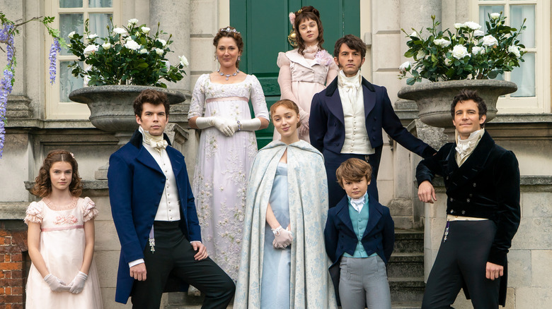 The Bridgerton family standing in front of their house