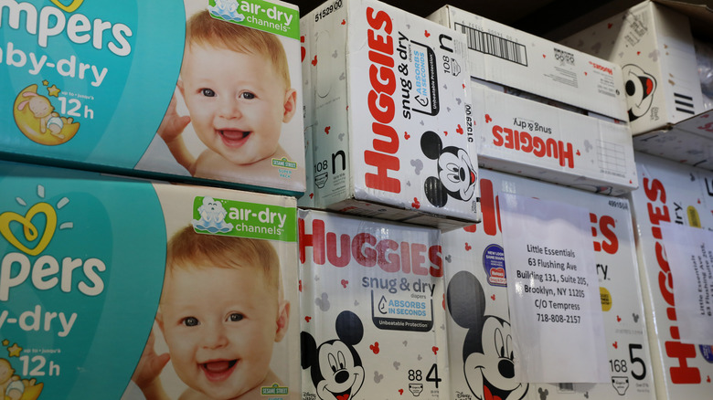 Boxes of Pampers and Huggies diapers on a store shelf