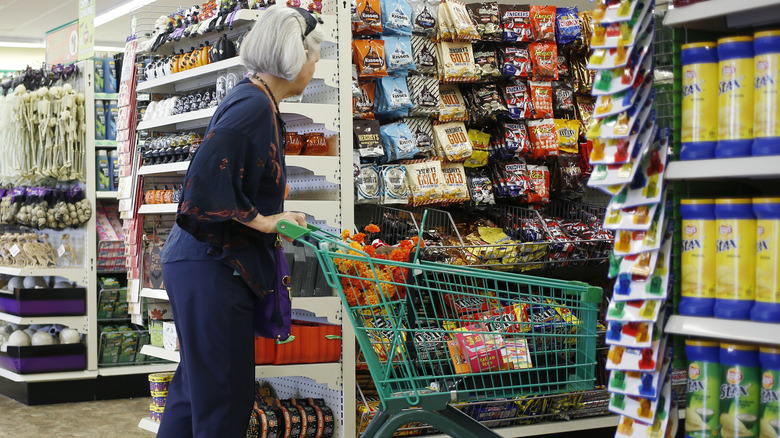 woman shopping groceries at dollar store
