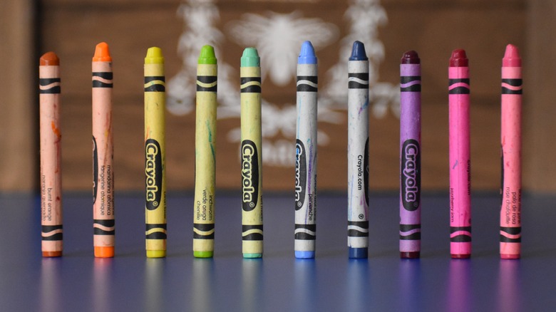 10 crayons standing on end on a table