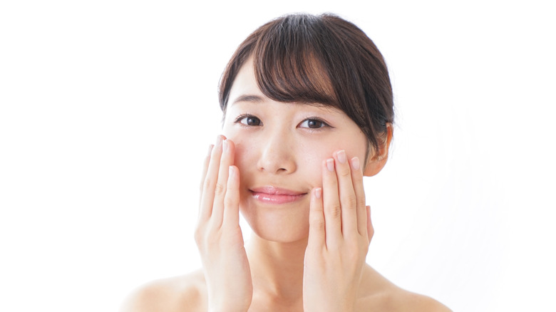 Woman scrubbing face