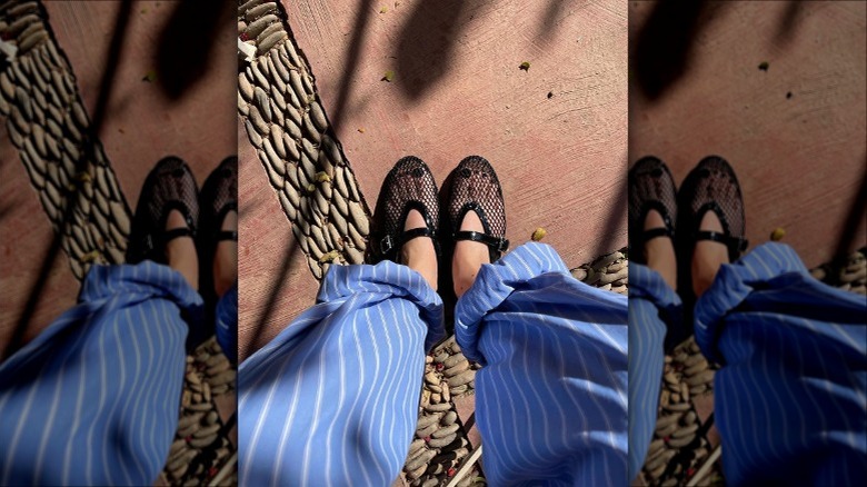 black mesh flats with striped linen pants