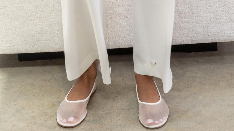 woman wearing white mesh flats