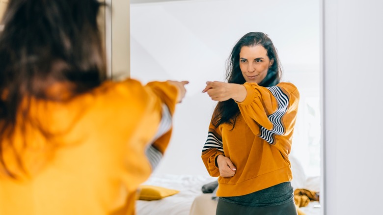 woman motivating herself in the mirror