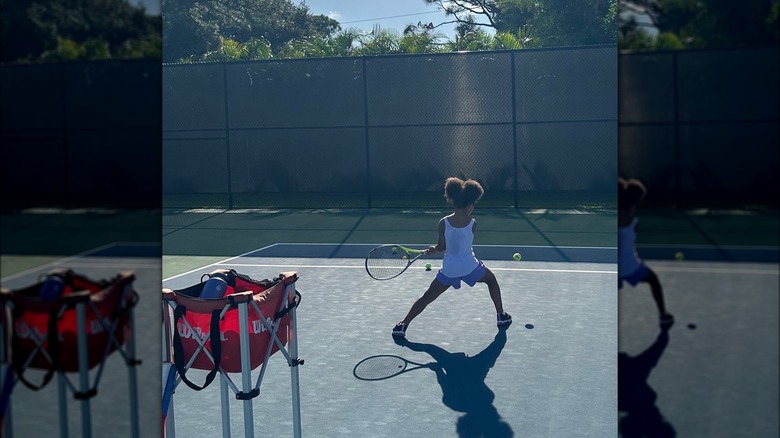 Olympia practicing with a racket