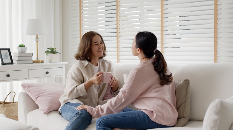 Mother and daughter talking over tea