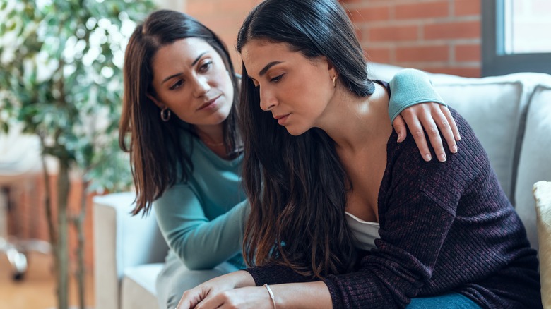 Woman comforting friend