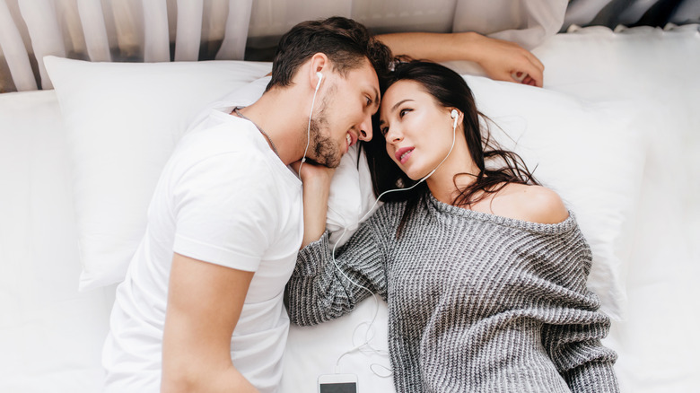 couple listening on headphones