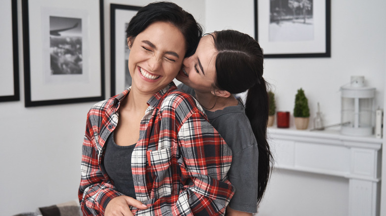 women hugging and laughing