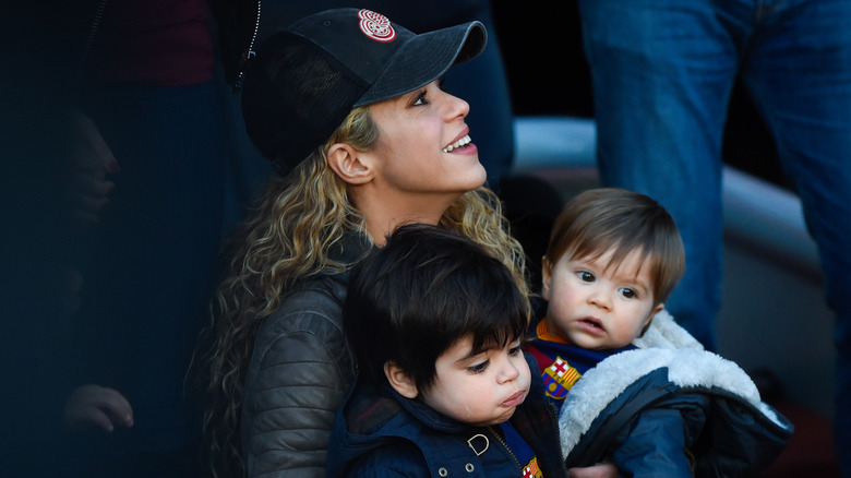 Shakira holding her two sons.